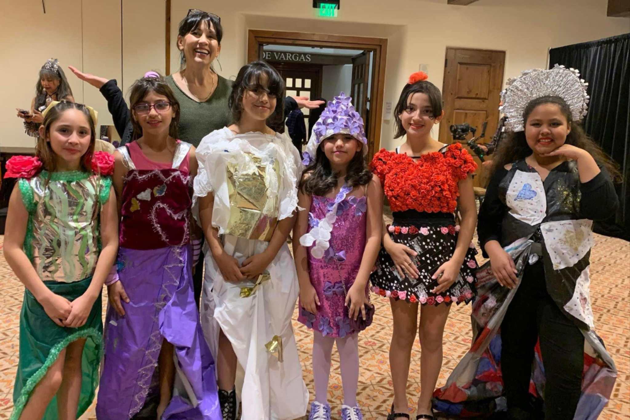 six girls wearing colorful costumes