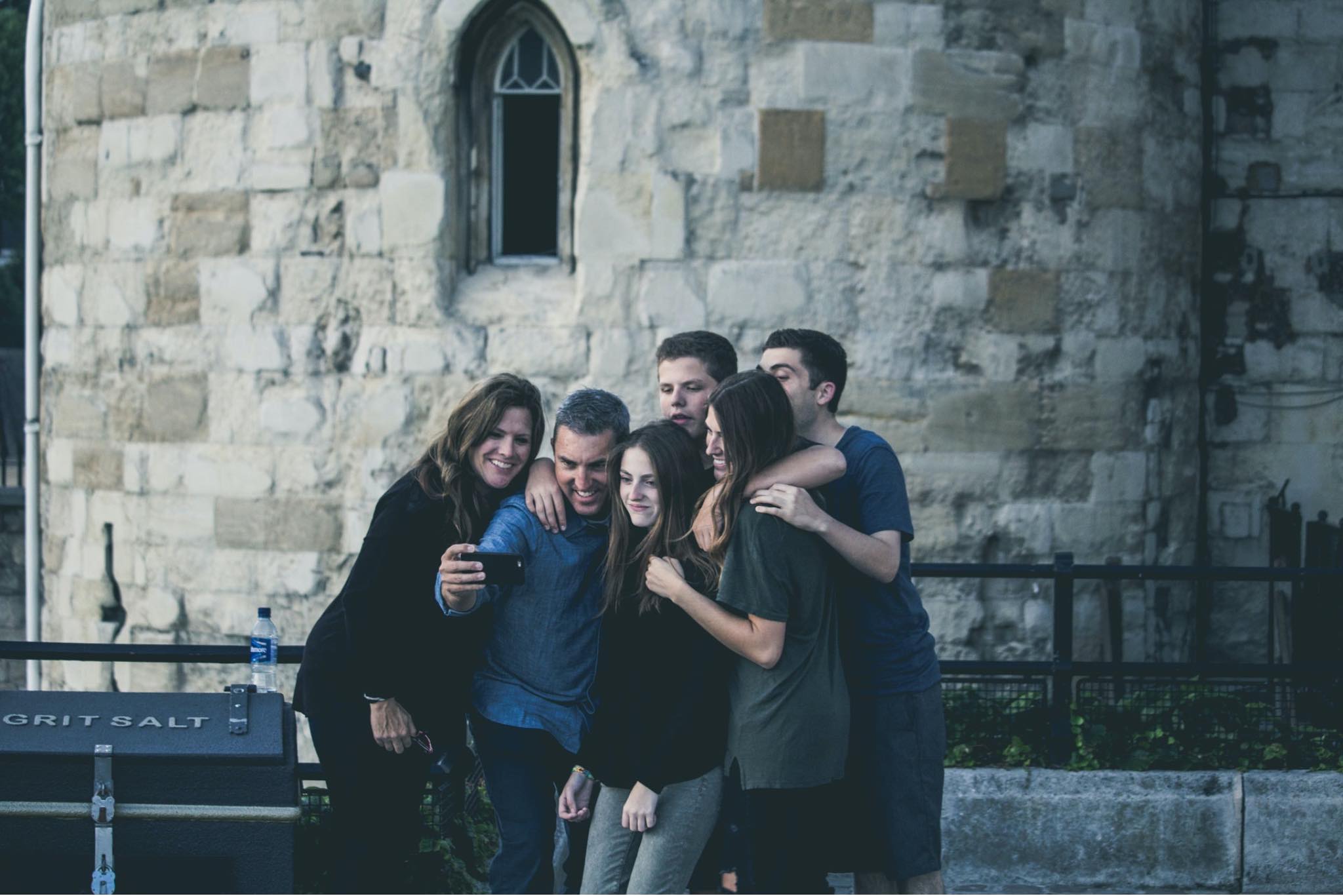family posing for selfie in front of church