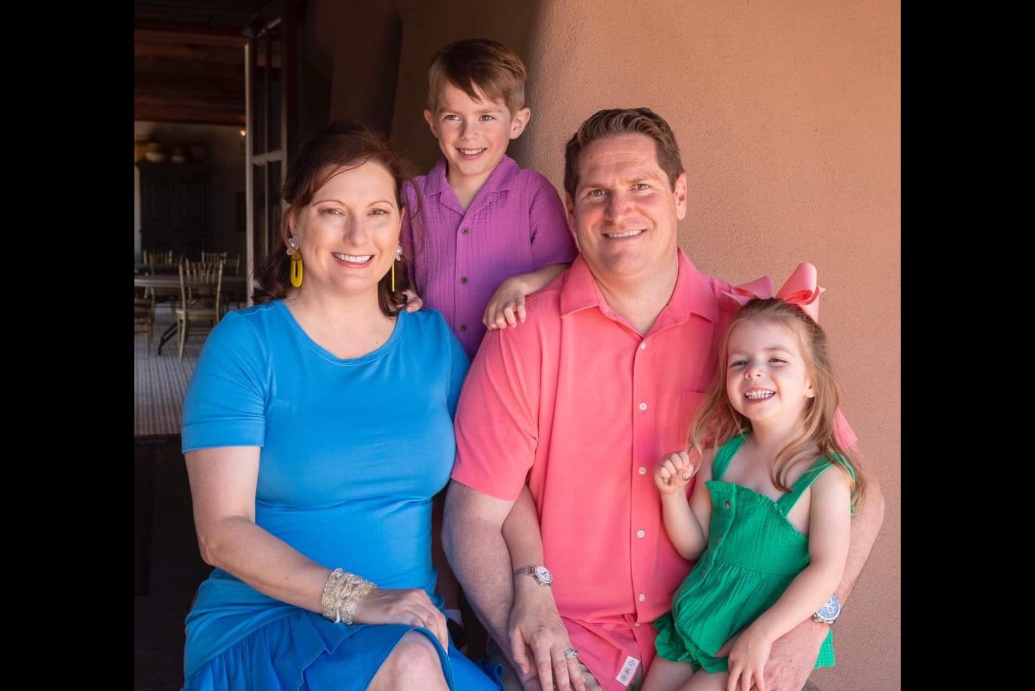 family smiling at camera