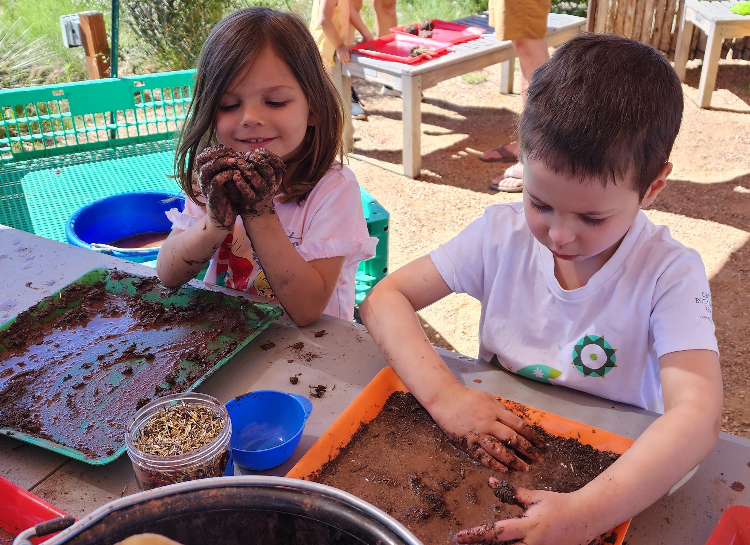 Families enjoying an Arts Alive! activity making seed balls.