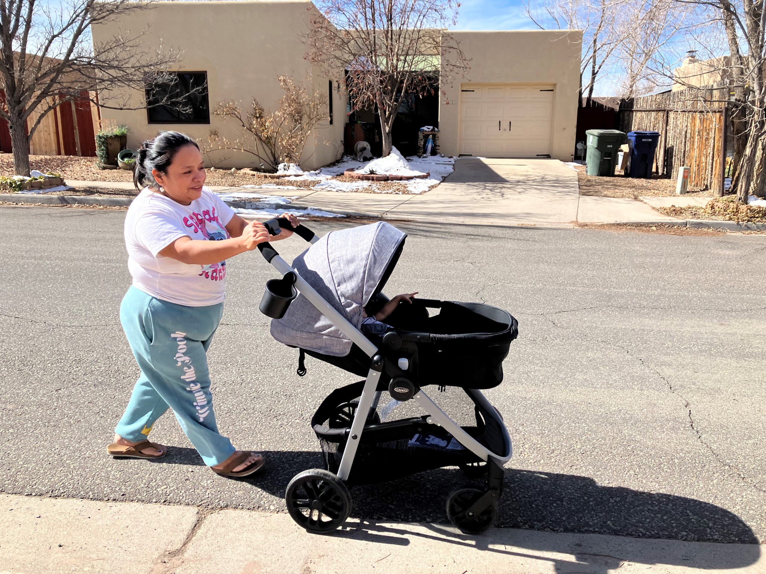 Mother and son take a spin around the block together.