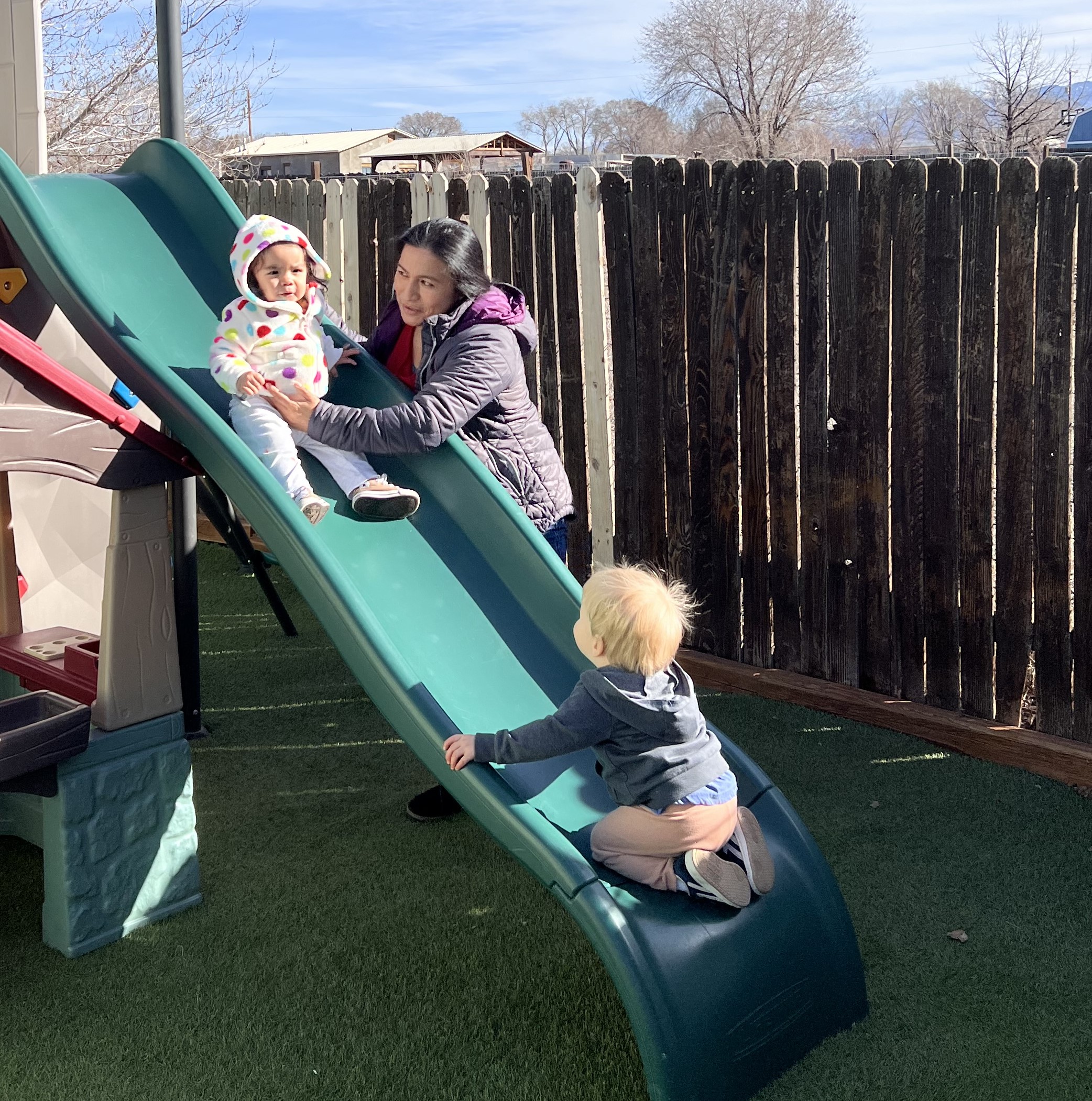 Lucia, helping children down the slide