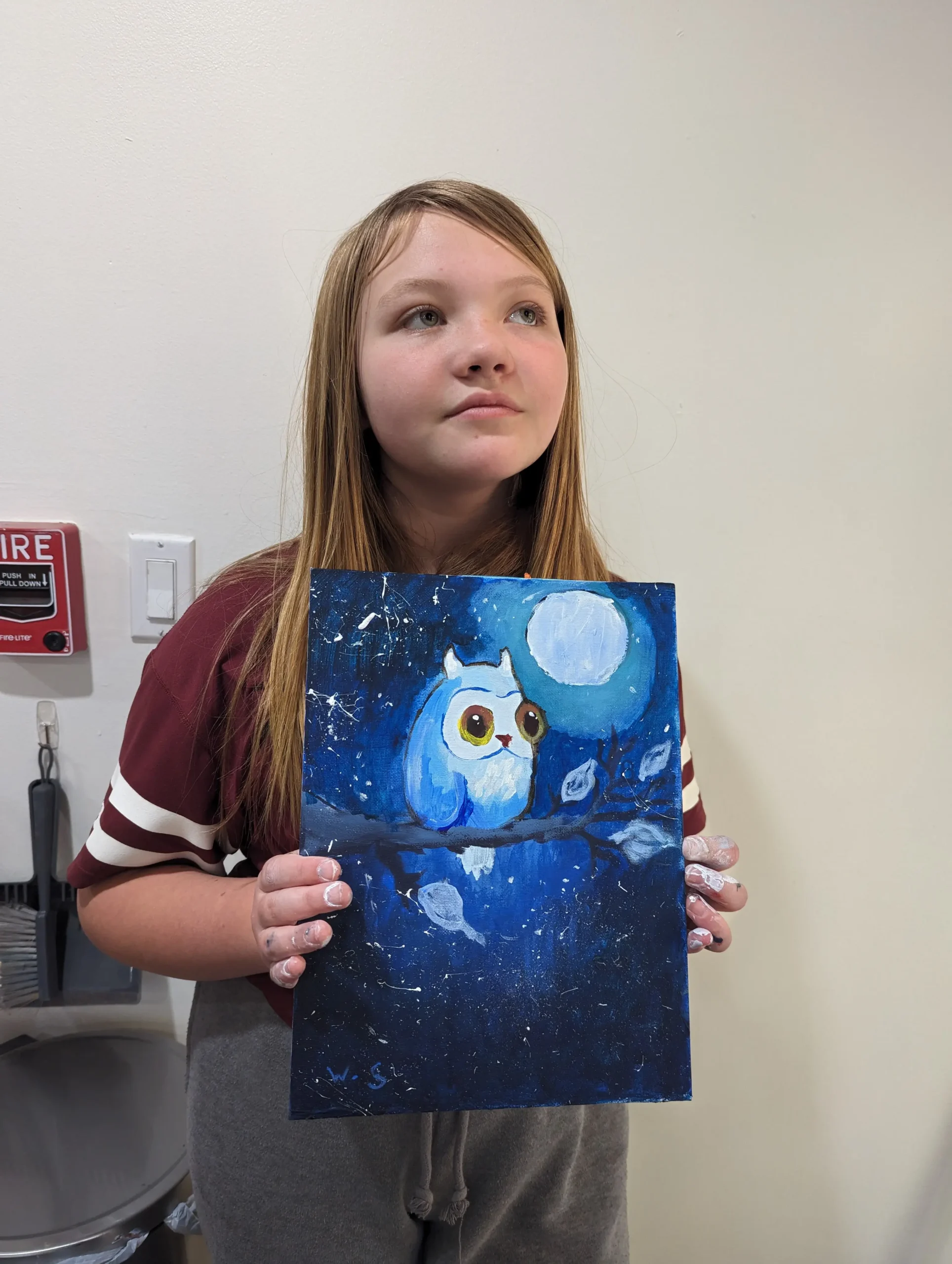 Girl holding artwork of owl