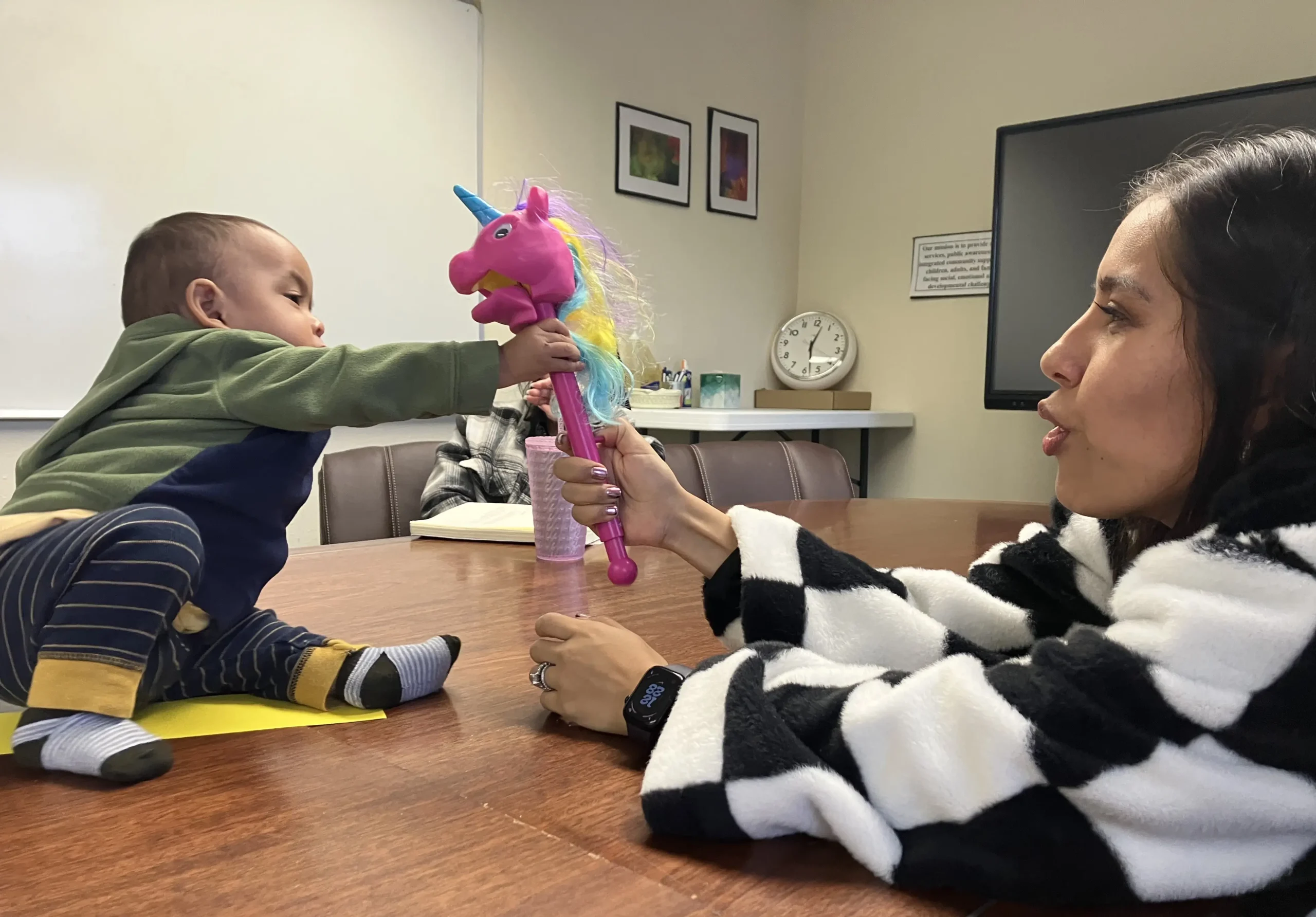 Confident Parenting team mem- bers observe during a collaborative family meeting.