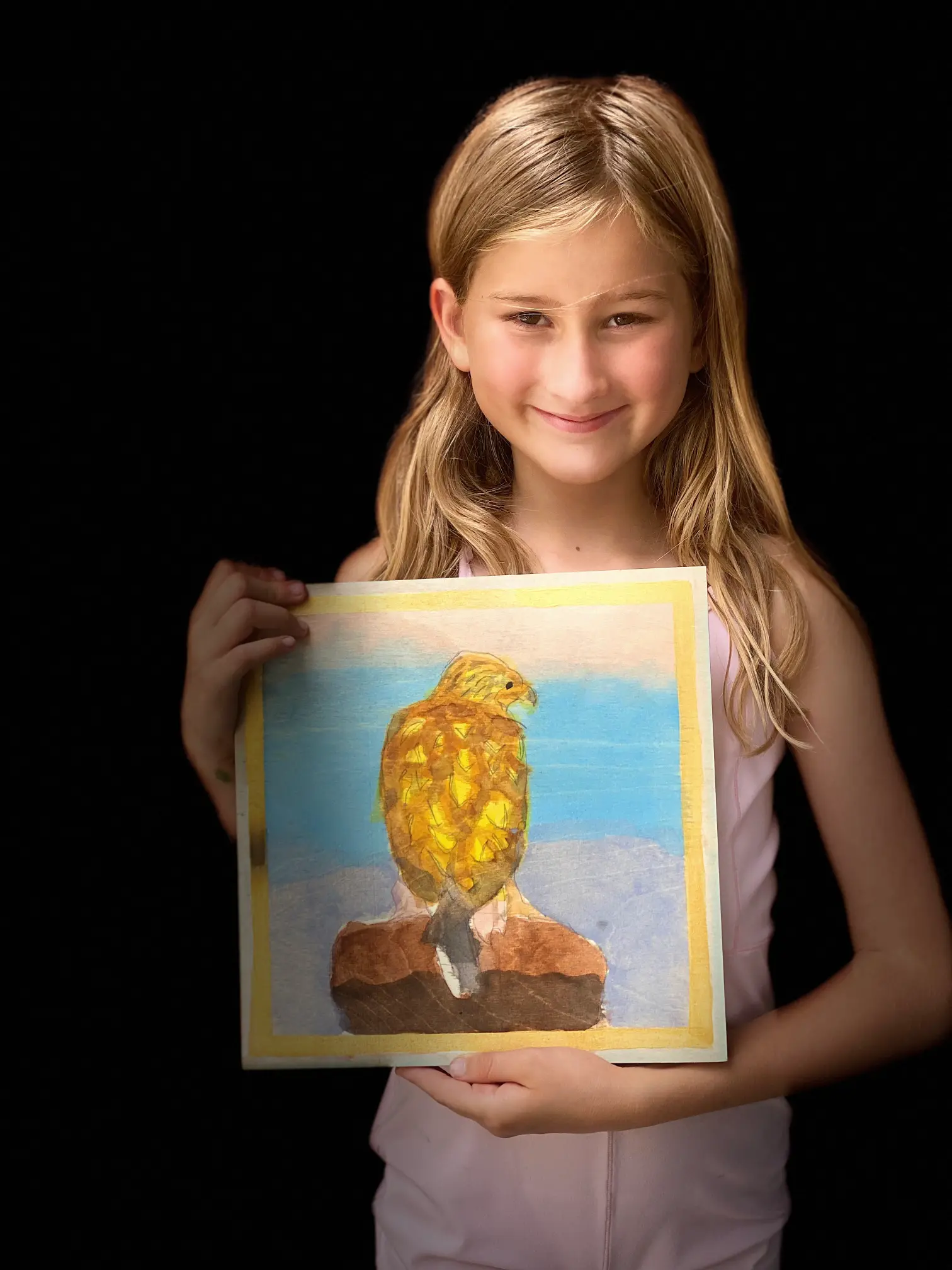 Student displaying her bird drawing