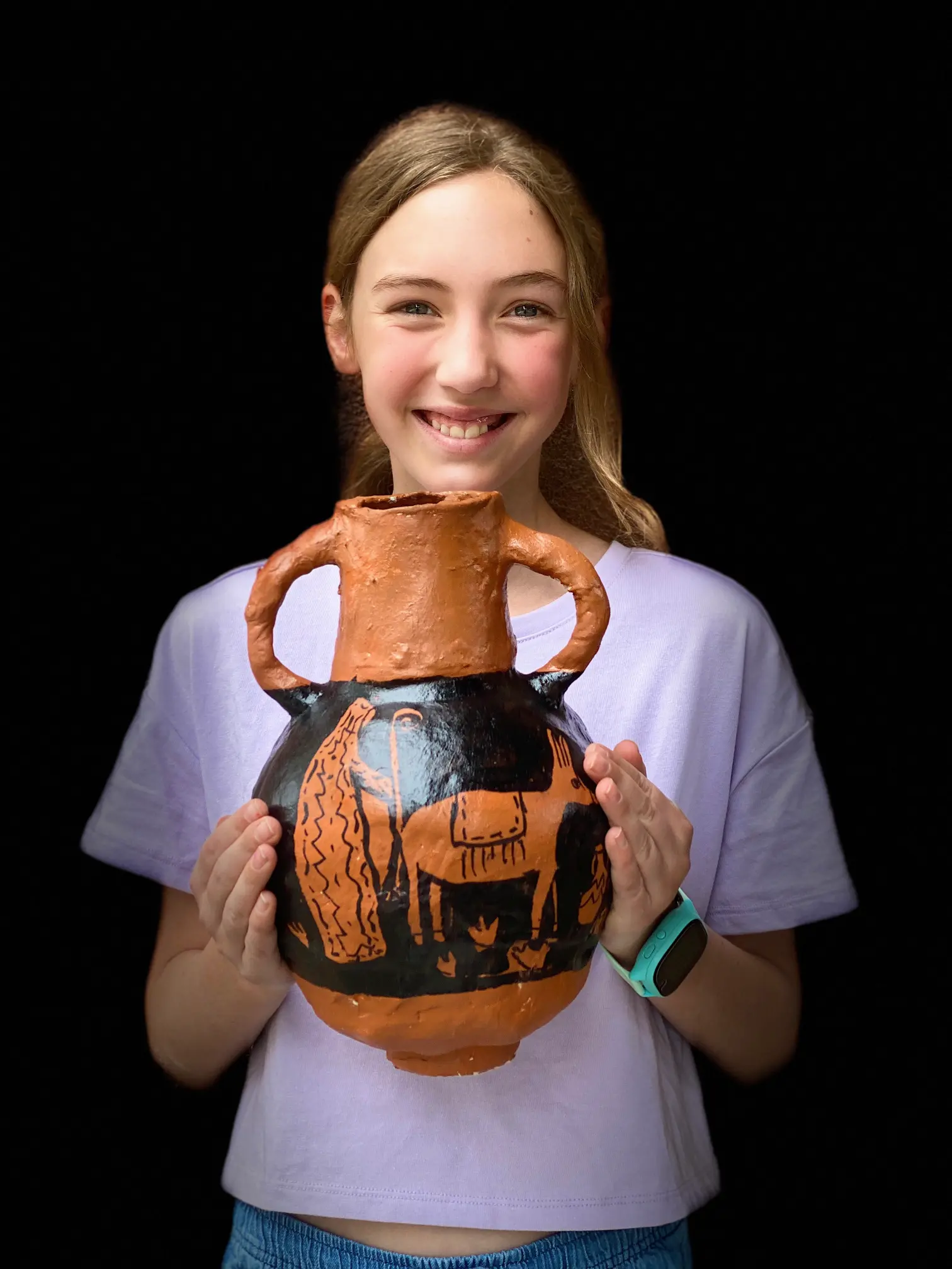 Student shows off her clay pot