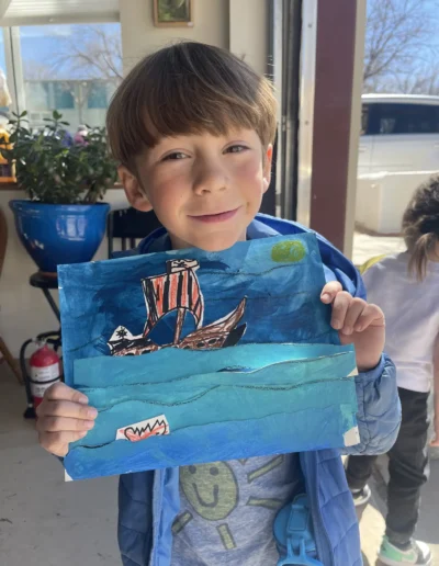 boy showing his painting