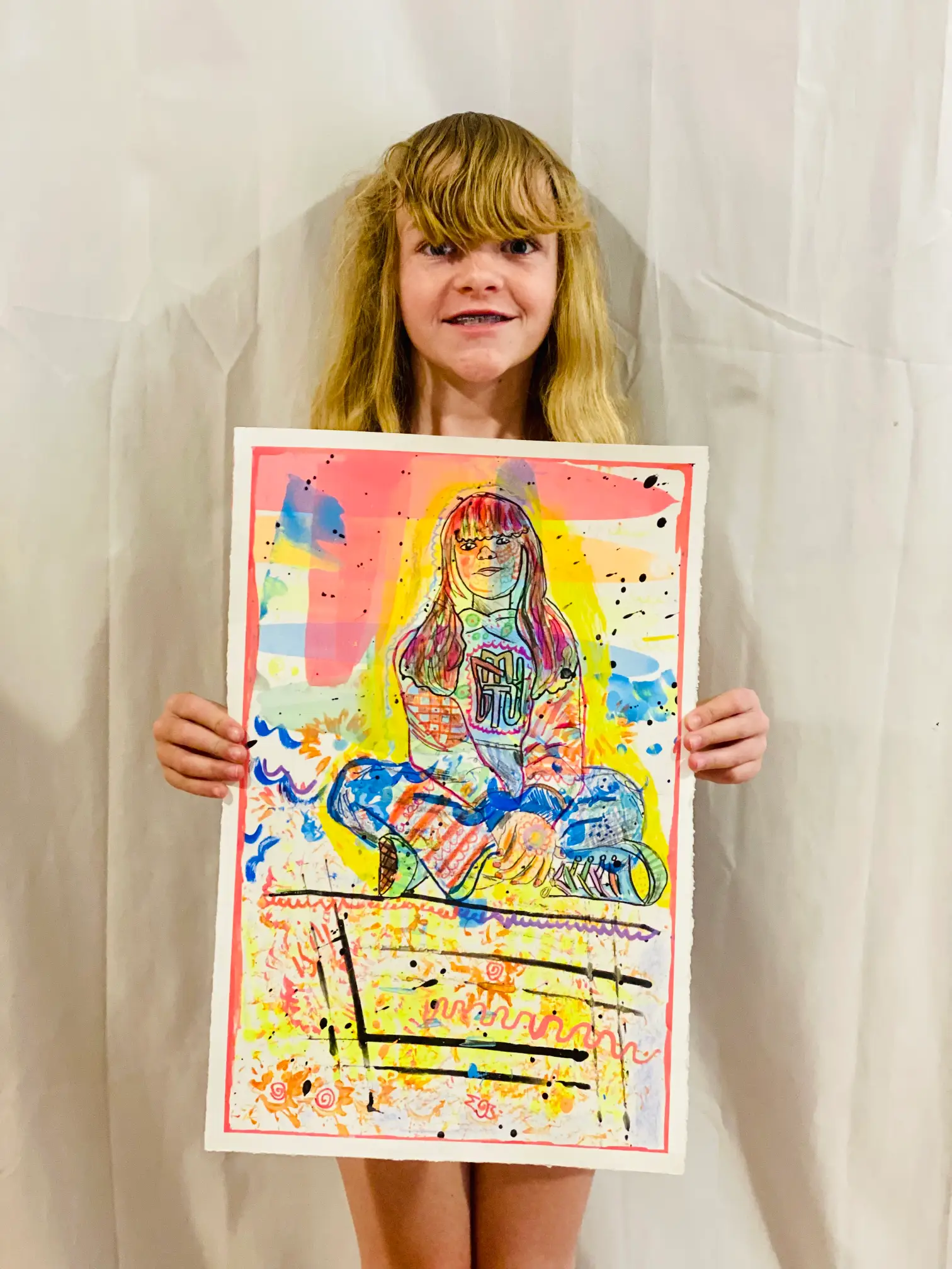 Student showing off artwork