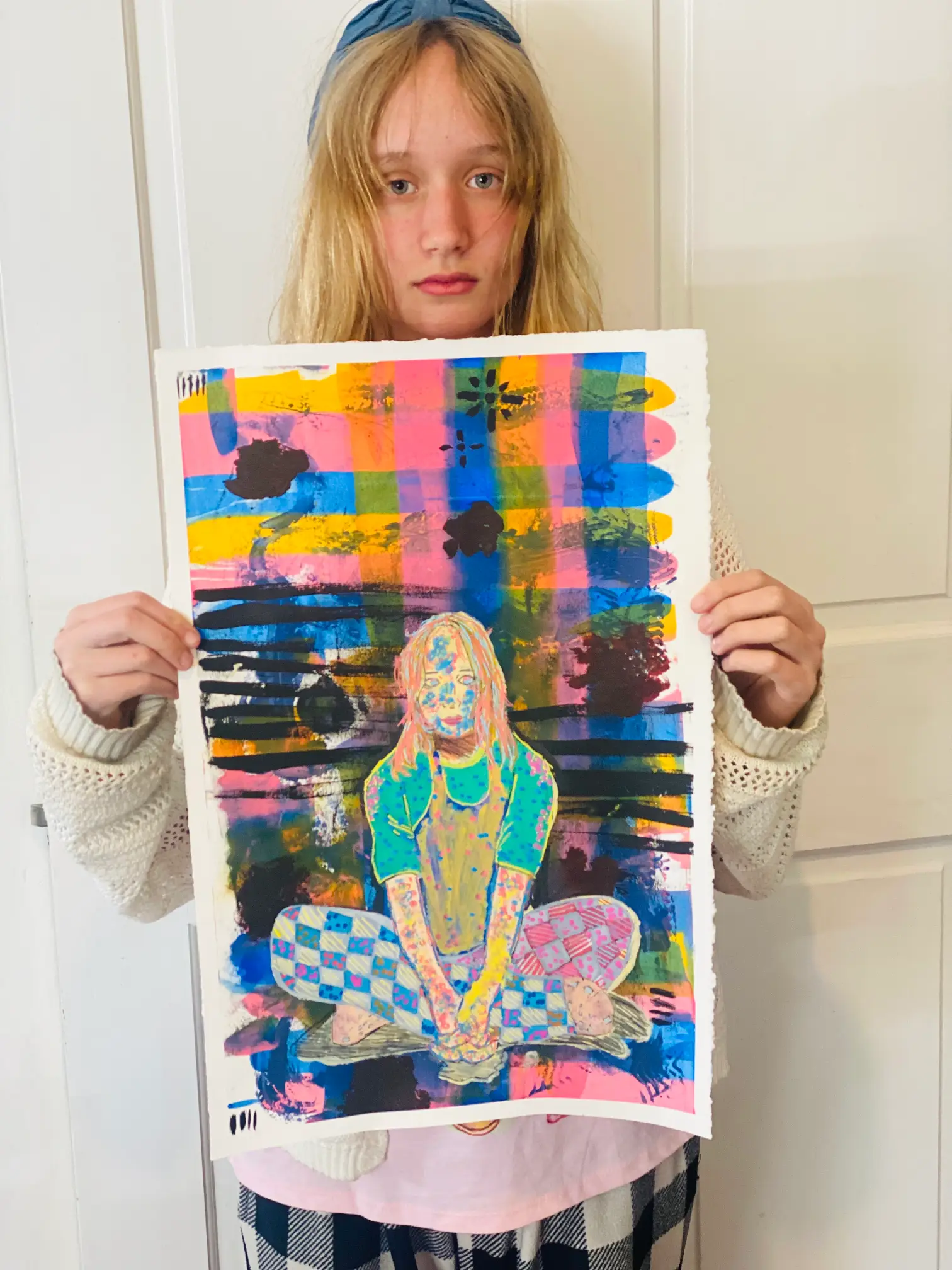 Student showing off artwork