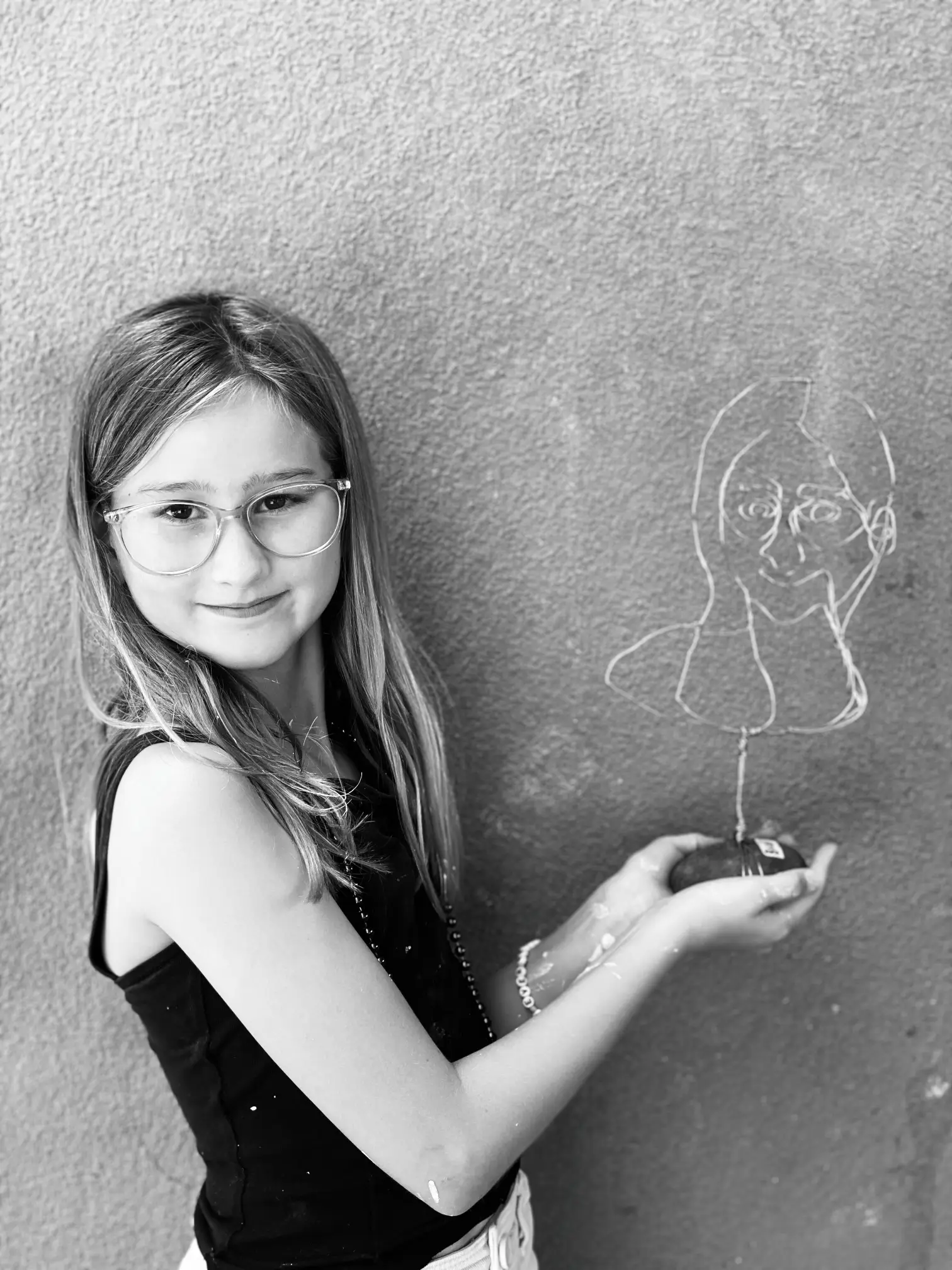 student drawing with chalk