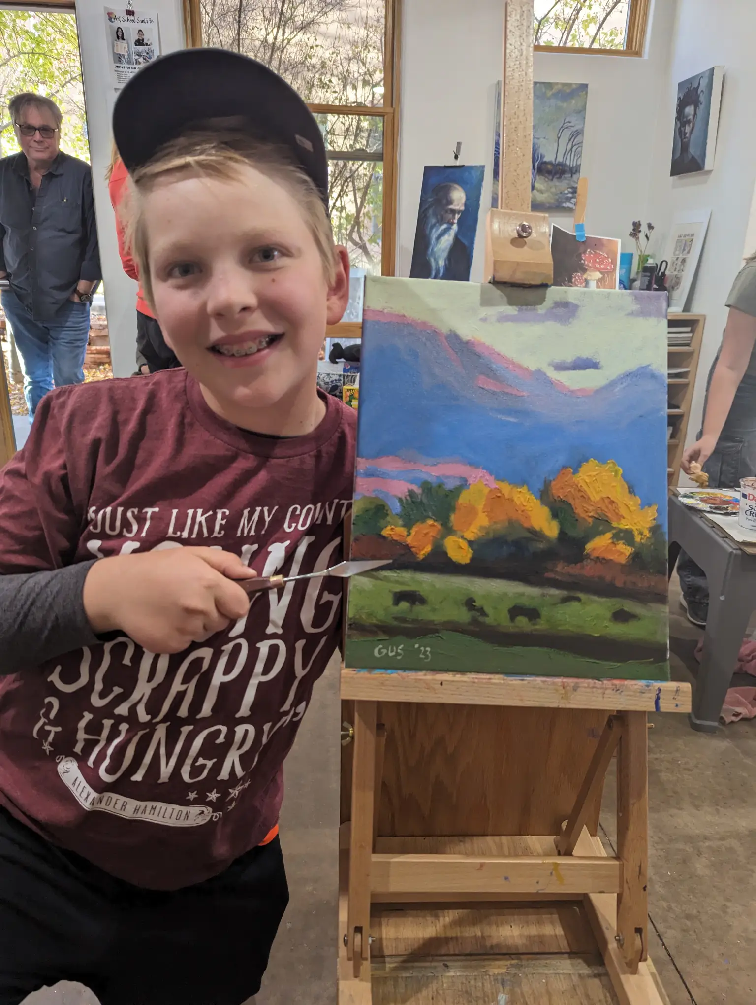 student shows off his artwork