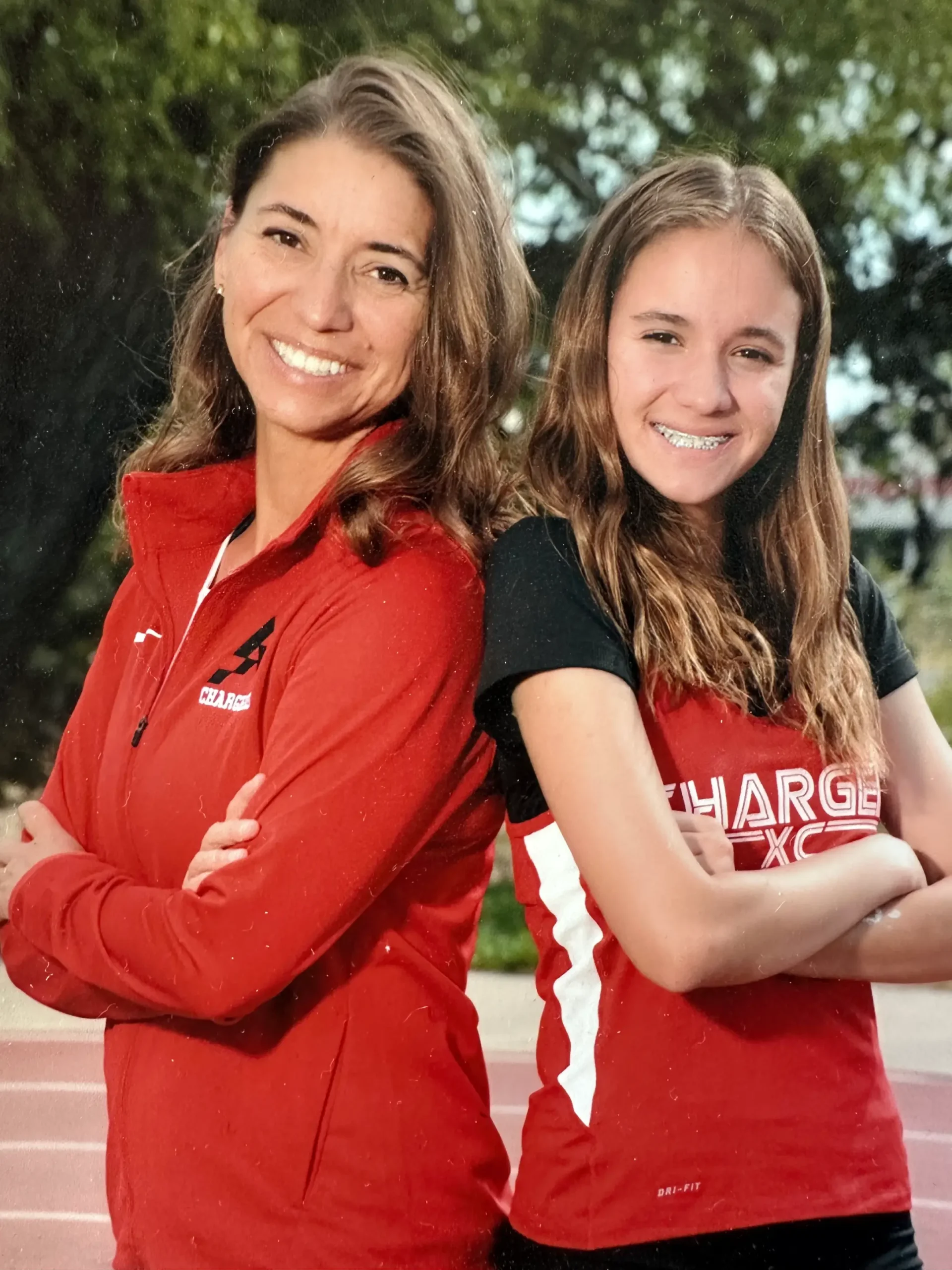 Pamela and her daughter take a team photo. Photo credit: Amigos Sports Photography